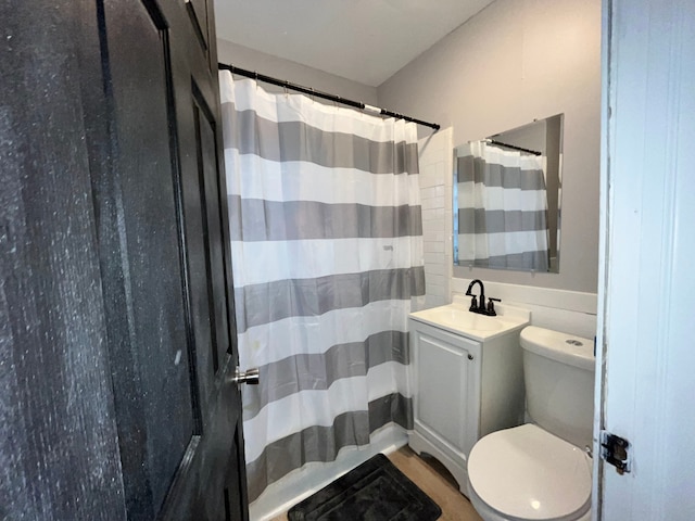 bathroom with vanity, a shower with shower curtain, and toilet