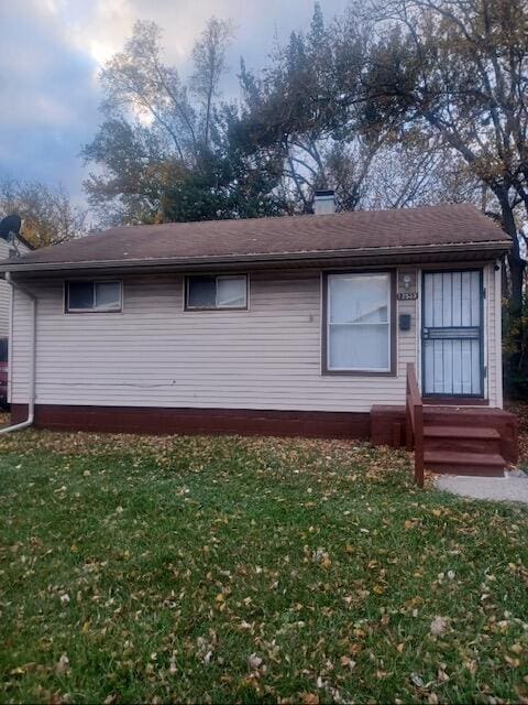 rear view of house with a lawn