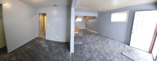 basement featuring dark colored carpet