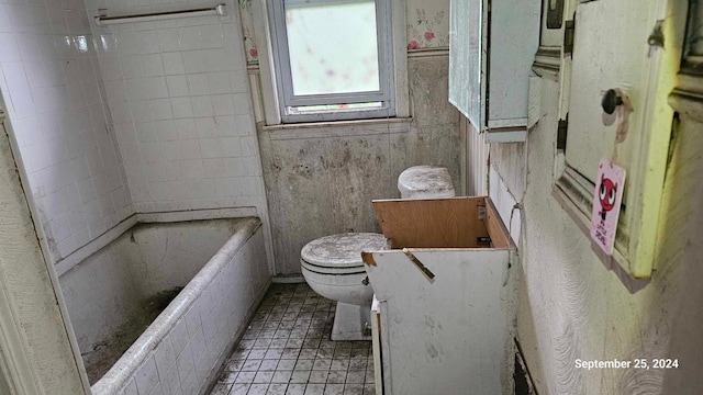 bathroom with tile patterned floors, a bathtub, toilet, and vanity