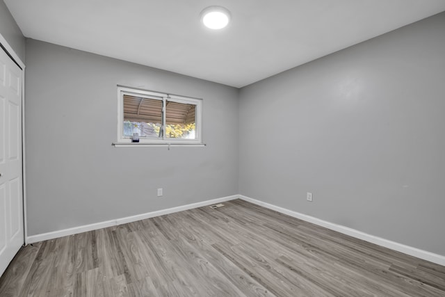 unfurnished bedroom with a closet and light hardwood / wood-style floors