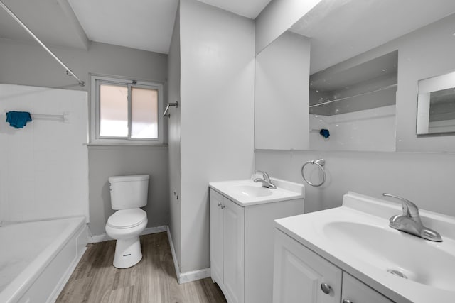 full bathroom featuring shower / washtub combination, toilet, vanity, and hardwood / wood-style flooring