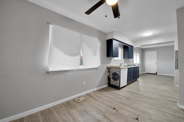 kitchen featuring ceiling fan, blue cabinetry, and light hardwood / wood-style flooring