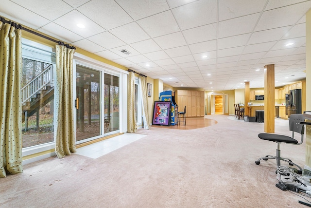 exercise area with carpet and a paneled ceiling