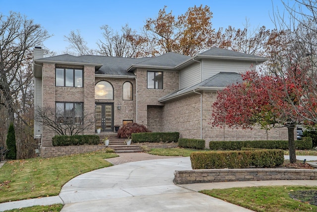 view of front of home with a front yard and french doors