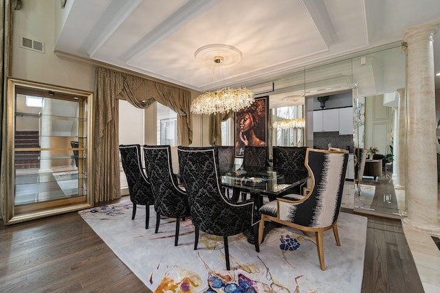 dining space featuring a chandelier, ornate columns, wood-type flooring, and a tray ceiling