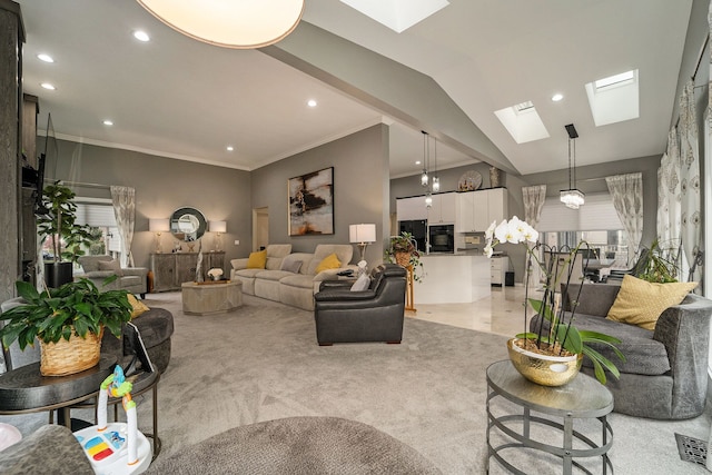 carpeted living room with vaulted ceiling with skylight and ornamental molding