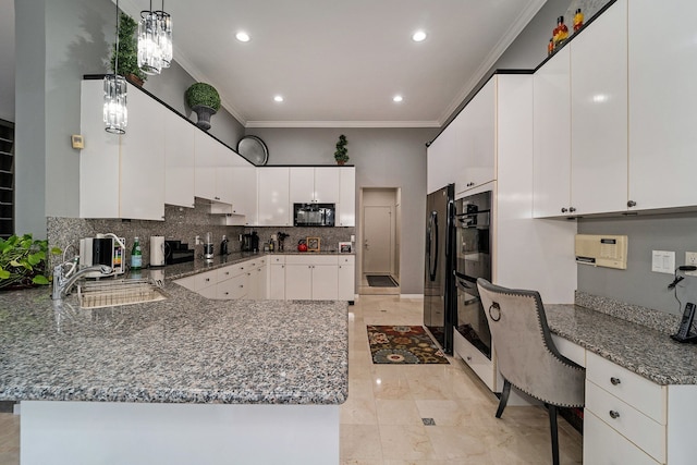 kitchen with pendant lighting, black appliances, kitchen peninsula, sink, and white cabinetry