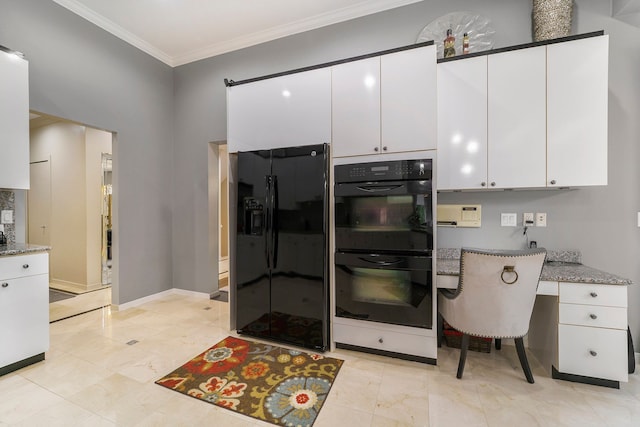 kitchen featuring light stone countertops, ornamental molding, black appliances, built in desk, and white cabinets