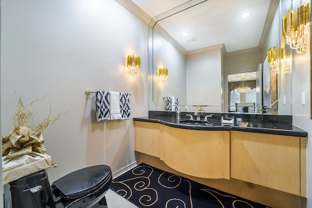 bathroom featuring vanity, toilet, and crown molding