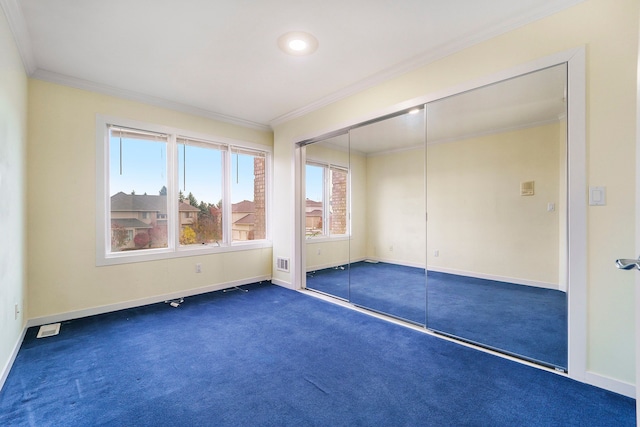 empty room with dark carpet and ornamental molding