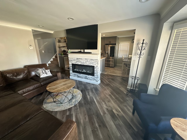 living room featuring a fireplace and dark wood-type flooring