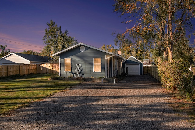 view of front of home with an outbuilding, a yard, and a garage