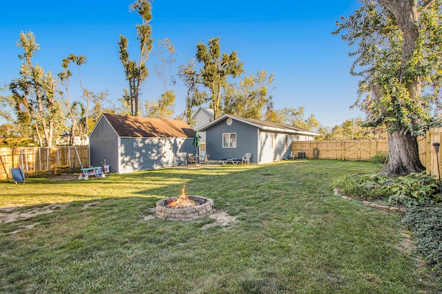 view of yard with an outdoor fire pit and an outdoor structure