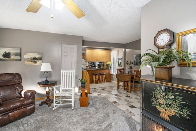 living room with a textured ceiling and ceiling fan