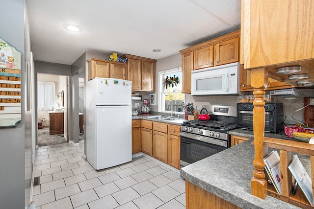 kitchen featuring white appliances and sink