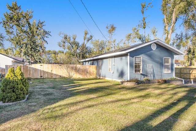 view of side of home with a lawn