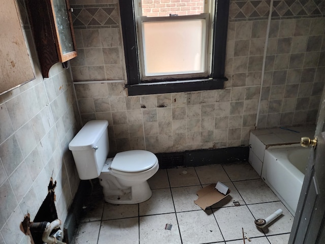 bathroom featuring a bath, toilet, tile walls, and tile patterned floors