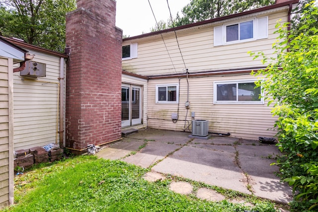 rear view of property with a patio and central AC