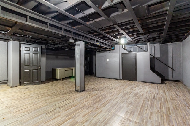 basement with light hardwood / wood-style floors