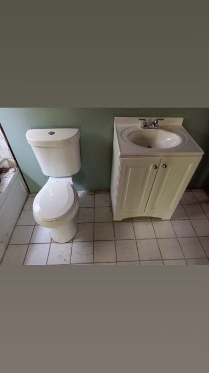 bathroom featuring toilet, vanity, and tile patterned floors