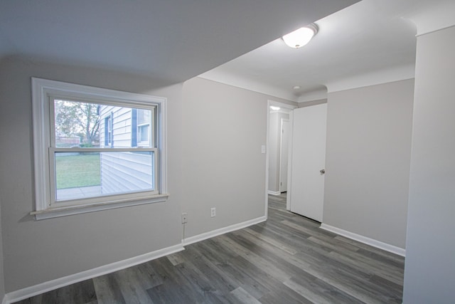 unfurnished room featuring dark hardwood / wood-style flooring