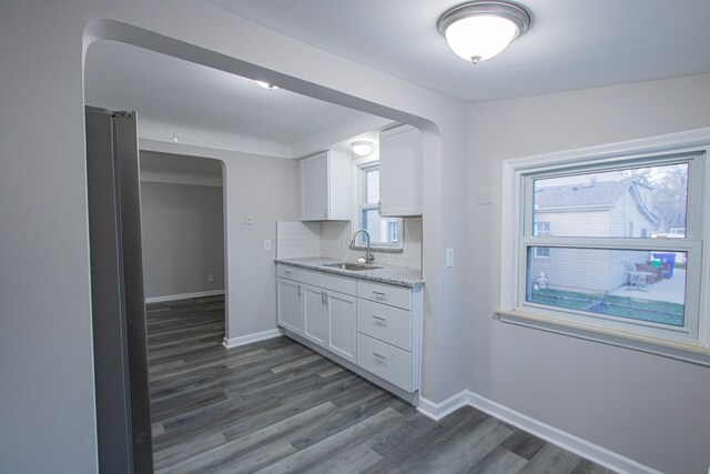 kitchen featuring plenty of natural light, sink, white cabinetry, and dark wood-type flooring