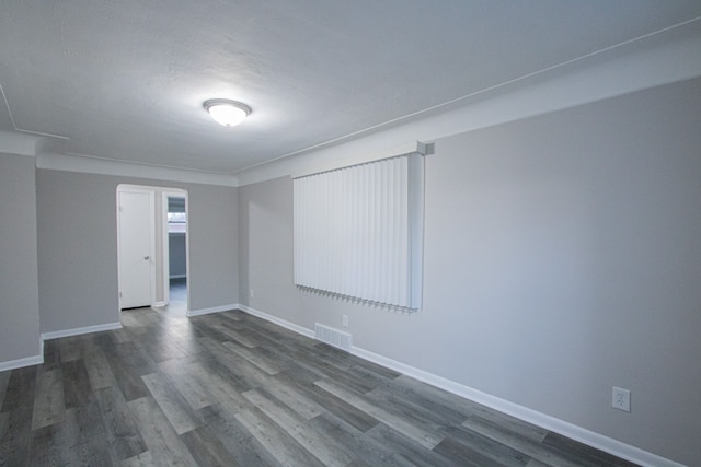 spare room with dark wood-type flooring