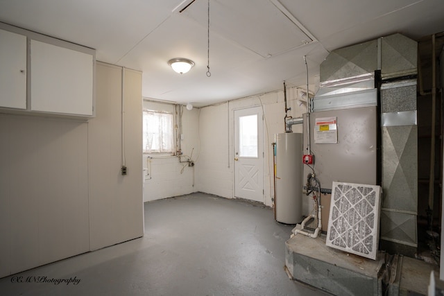 below grade area featuring concrete block wall, water heater, and heating unit