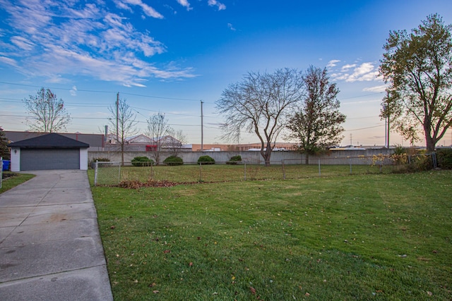 view of yard with a garage, an outdoor structure, and fence