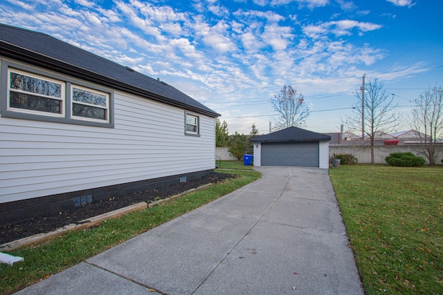 view of side of property with a garage, an outdoor structure, fence, crawl space, and a lawn