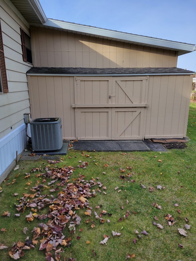 view of outbuilding with a yard and cooling unit