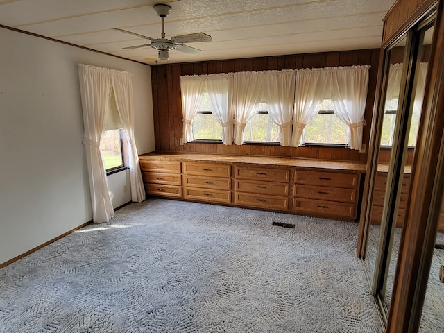 carpeted empty room featuring ceiling fan and a textured ceiling