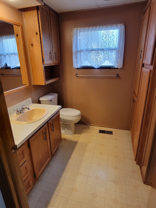 bathroom with vanity and toilet