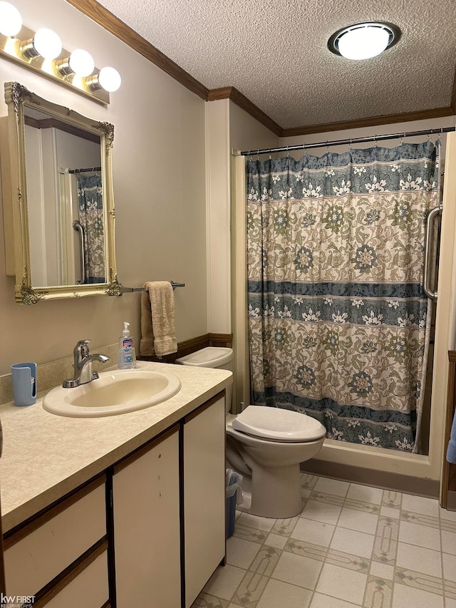 bathroom featuring vanity, a textured ceiling, toilet, and ornamental molding