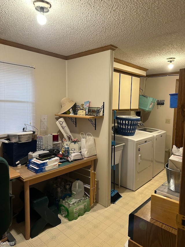 laundry area with washing machine and clothes dryer, a textured ceiling, and ornamental molding