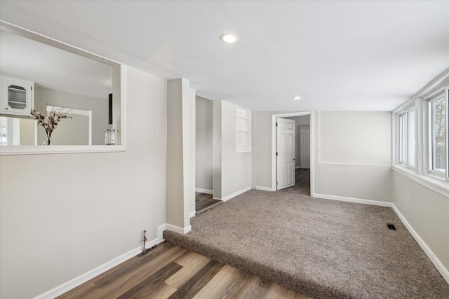 interior space featuring recessed lighting, visible vents, baseboards, and wood finished floors