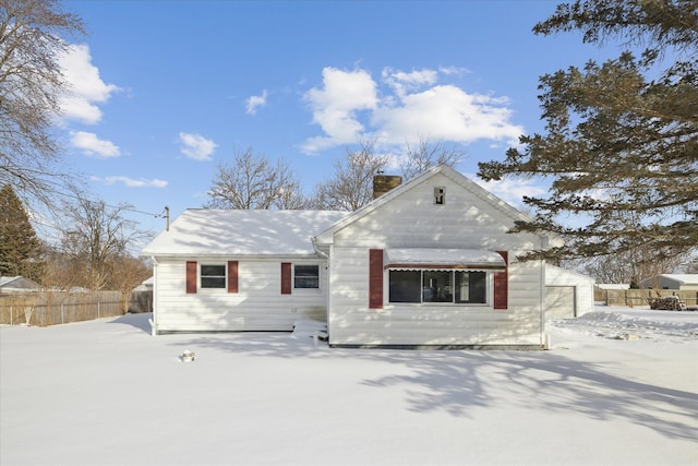 view of front of home featuring fence and a chimney