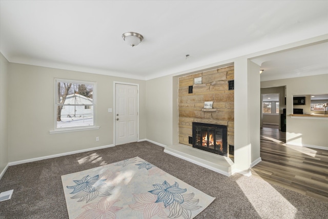 living area featuring a fireplace and baseboards