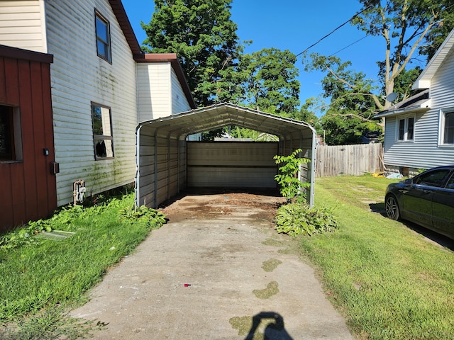 view of side of property with a lawn and a carport