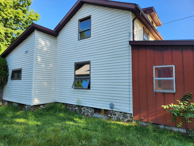 view of property exterior with a yard