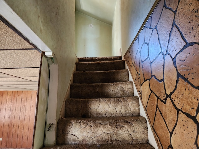 stairway featuring vaulted ceiling