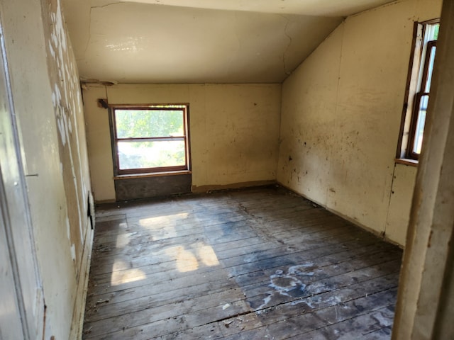 spare room with dark hardwood / wood-style floors and vaulted ceiling