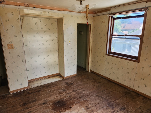 unfurnished room with dark wood-type flooring