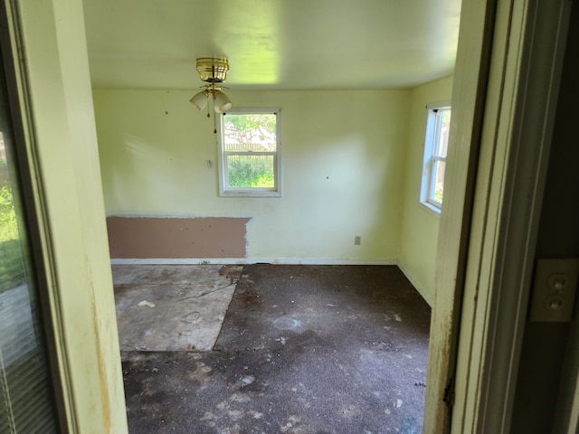 315 Mcomber St, Dowagiac, MI 49047 - empty room with plenty of natural light, baseboards, and a ceiling fan