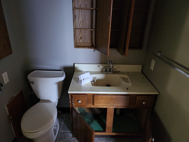 315 Mcomber St, Dowagiac, MI 49047 - half bathroom with toilet, vanity, and tile patterned flooring
