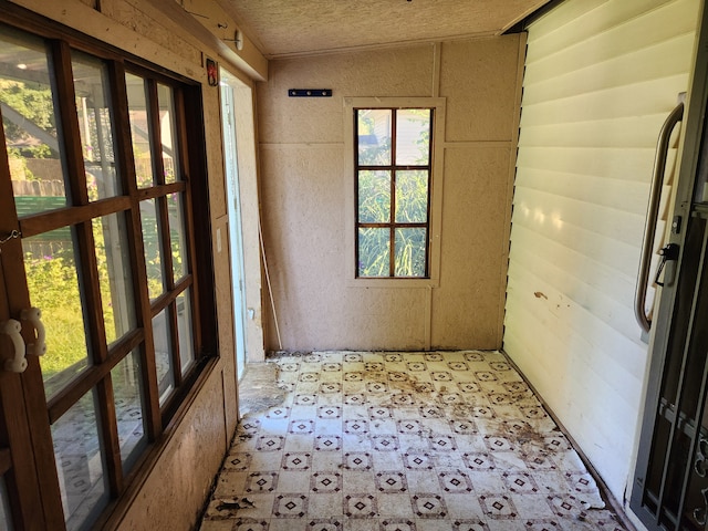 unfurnished sunroom with lofted ceiling