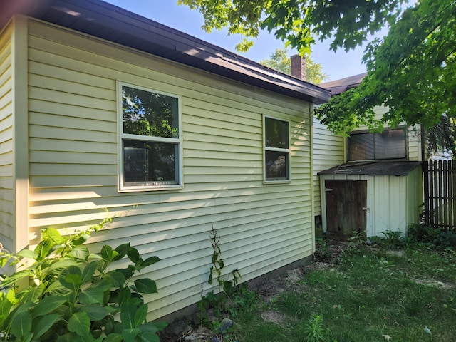 view of side of property with a storage unit