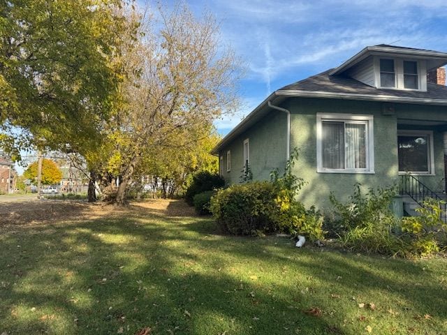 view of side of property with a yard