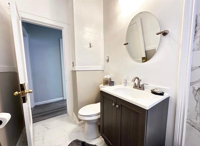 bathroom featuring vanity and toilet